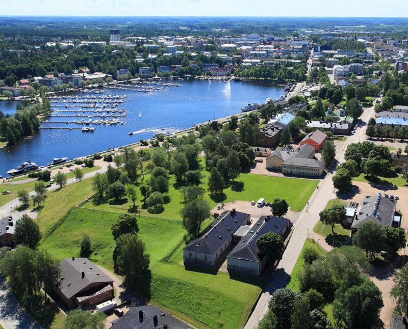 The Lappeenranta Fortress from above. The sun is shining and there are multiple historical buildings. Harbour of the Lappeenranta is in the background.